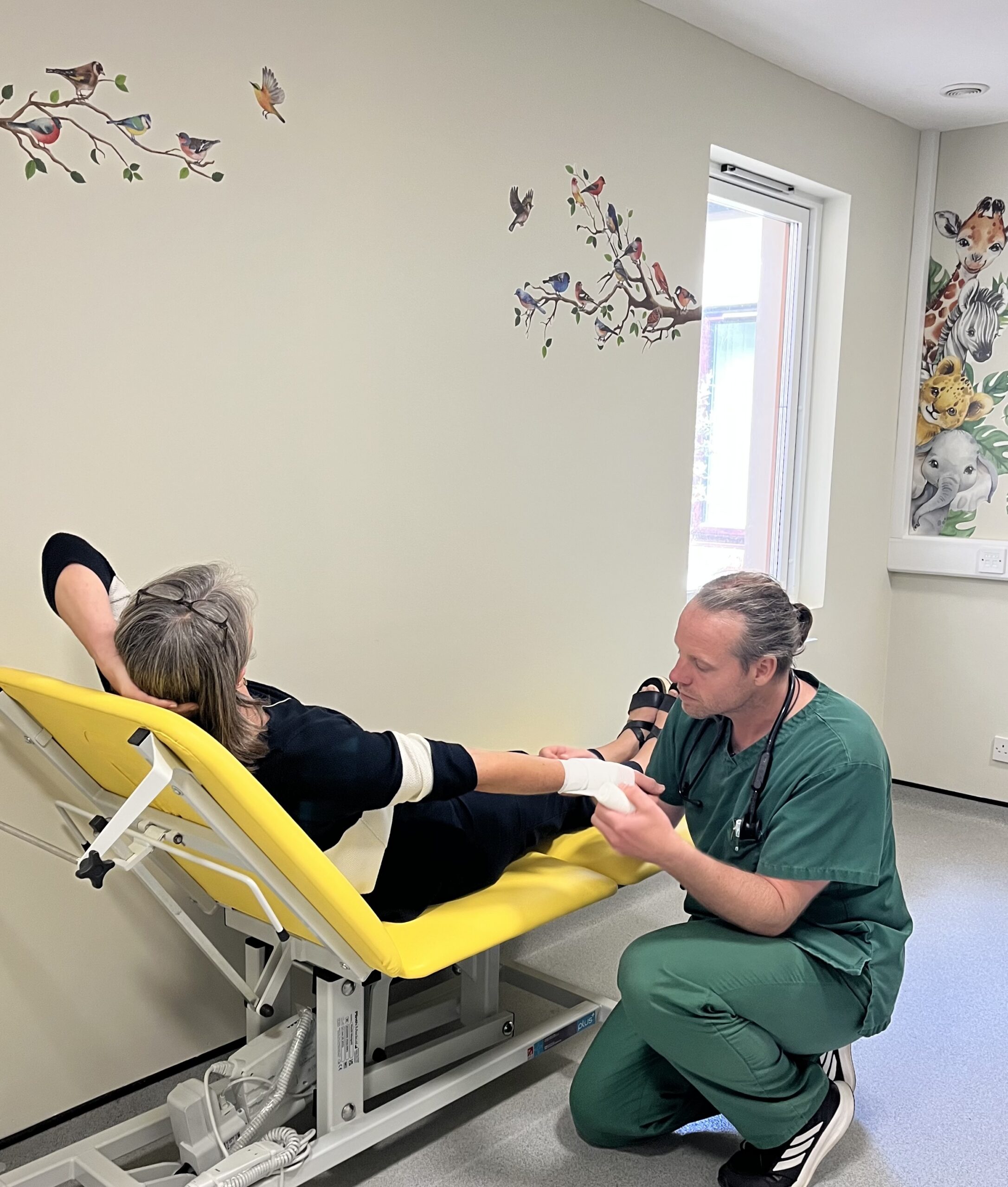 Paramedic treating patient in new Minor Injuries room.